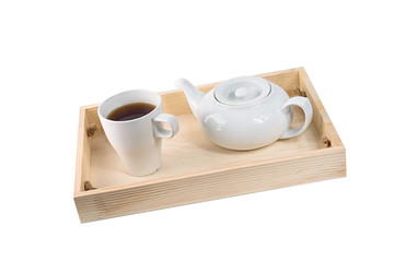 Teapot and cup on wood isolated on white