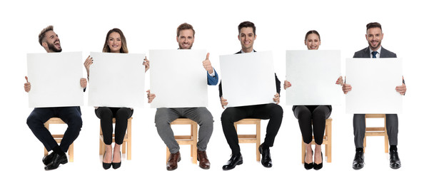 Team of 6 businessmen holding blank billboard