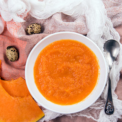 Cream of pumpkin soup with boiled egg. Fresh fragrant pumpkin cream soup on white bowl