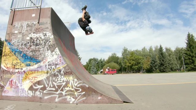 Backflip on skates in skatepark in slow motion - extreme sports