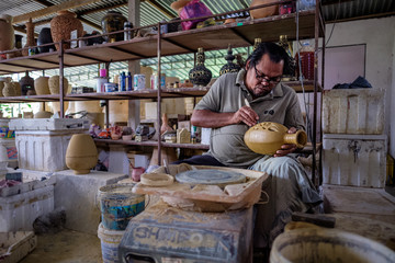 Local craftsman demonstrates on making traditional clay jar called "Labu Sayong" or Essence Jar of Sayong at Kuala Kangsar, Perak, Malaysia.