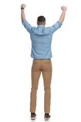 Rear view of positive casual man celebrating