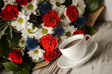 Cup of coffee with bouquet of flowers