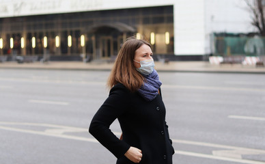 Fototapeta premium young european woman in protective disposable medical mask. concept protection of dangerous 2019-nCoV influenza coronavirus, mutated and spreading in China