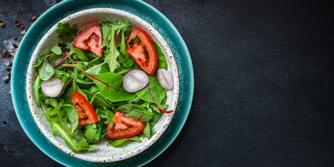 healthy salad tomato, mix leaves, onions and other ingredients, vegan, keto or paleo menu concept. top food background. copy space