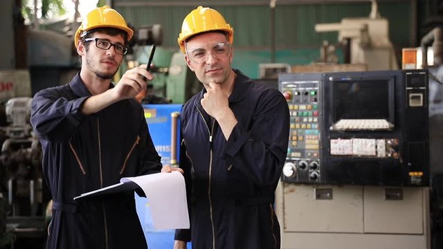 Group of industrial factory maintenance engineers inspect relay protection system using walkie talkie with copy space for your text. Industry, Maintenance, Engineering and construction concept.