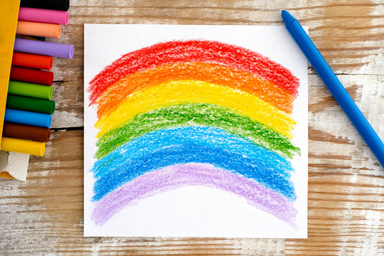 Hand drawing Rainbow with wax crayons.