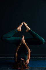 girl doing yoga in a dark place