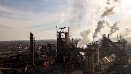 Obraz na płótnie Canvas Steel ecology metallurgical iron plant smokes from pollution of industry pipes. View from the drone.