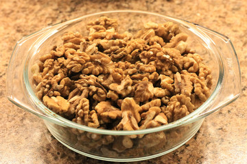 plate with peeled walnuts, background, texture