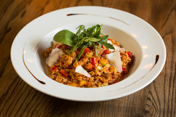 Risotto with chicken meat, zucchini and mushrooms in cream sauce