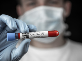 Test tube sample Coronavirus test in hand or researcher in rubber glove, yound researcher in the...