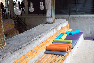 Recreation places with wooden benches and colored pillows indoors