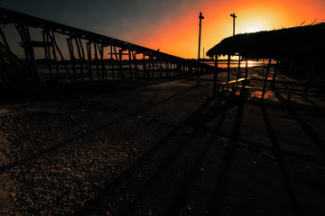 Fototapeta na wymiar old wooden pier at sunset
