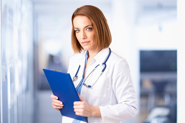 Attractive female doctor portrait while standing in the hospital