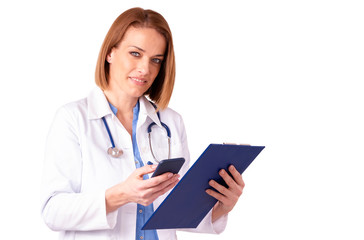 Mature female doctor text messaging while standing at isolated white background