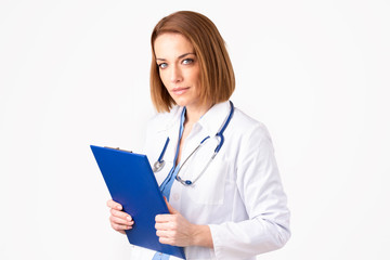 Portrait of middle aged female doctor standing at isolated white background