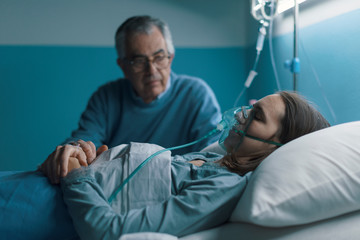 Senior man assisting her daughter at the hospital
