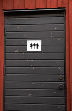 Gender neutral toilette WC door in Sweden with three figures woman, man and the third