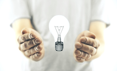 Hand holding light bulb
