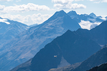 Drone flies mountains and peaks landscape in the background. Hills covered with glaciers and snow, natural environment. Hiking in the Gaislach. Ski resort in Tirol alps, Austria, Europe