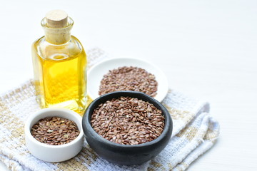 Fototapeta na wymiar Flaxseed or flaxseed seeds, accompanied by oil (Linum usitatissimum) displayed in containers
