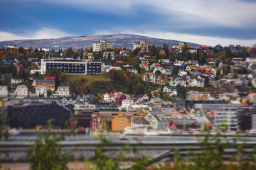 View of Tromso, with cathedral, Tromso Bridge, Tromsoya island, embankment and scenery beyond the city, Troms og Finnmark county, Norway, summer day