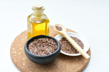 Flaxseed or flaxseed seeds, accompanied by oil (Linum usitatissimum) displayed in containers