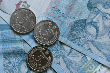 Five grivna hrivnya new coins and old paper bill. Money of Ukraine. Ukrainian national currency....