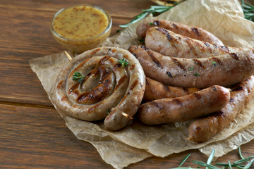 grilled sausages on a wooden background