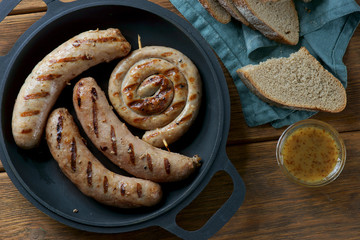 grilled sausages on a wooden background