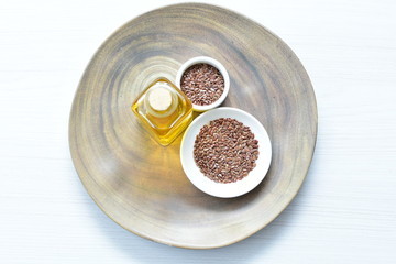 Flaxseed or flaxseed seeds, accompanied by oil (Linum usitatissimum) displayed in containers