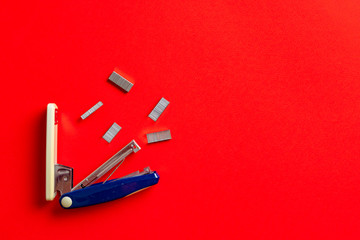 simple stapler and staples isolated on the colorful background in office table