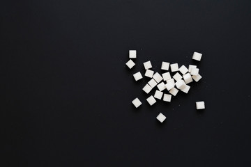 some bunch of sugar cubes flat lay on the colorful background, view from above, copy space