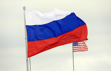 Russian flag on the background of the American flag