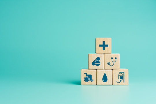 Health insurance concept, Wood blocks with healthcare medical icons on blue background, copy space