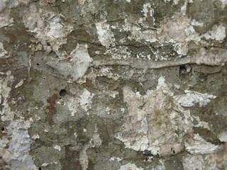 old concrete surface of the pillar with a lot of ads
