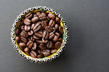 Colombian coffee beans, displayed in containers on black background