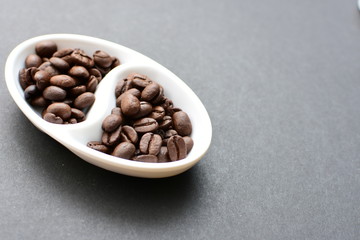 Colombian coffee beans, displayed in containers on black background