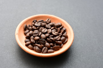 Colombian coffee beans, displayed in containers on black background