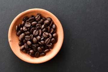 Colombian coffee beans, displayed in containers on black background