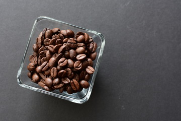 Colombian coffee beans, displayed in containers on black background