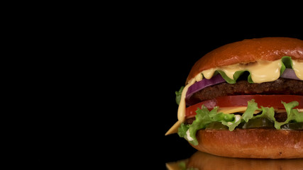 Hamburger on a black background. Close up.