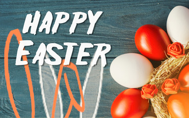 colored deep red Easter eggs in nest top view background, selective focus image. Happy Easter card