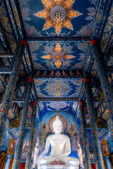 Main buddha statue located in the Blue Temple, the most iconic temple in Chiang Rai. A white big buddha statue.