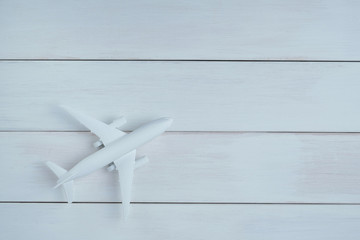 White airplane model on wooden background