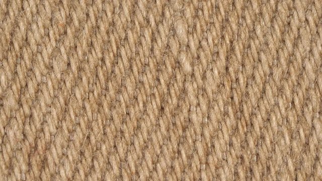 Textile background - 100 percent brown denim jeans cotton fabric. Weave pattern of threads close up. Macro shoot