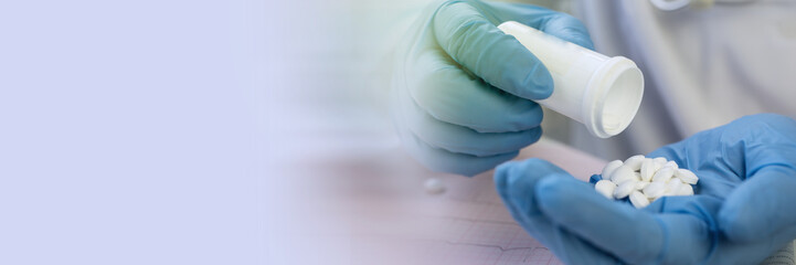 Medicine pills or capsules in hand, palm or fingers.