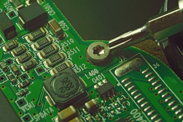 Micro circuit board bolt retainer close-up repair computer background engineering.