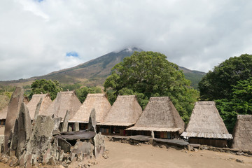 Inside view on the traditional Bena village in Bajawa, Flores, Indonesia. There are many small houses around, made of natural parts like wood and straw. History and tradition mingling with presence.